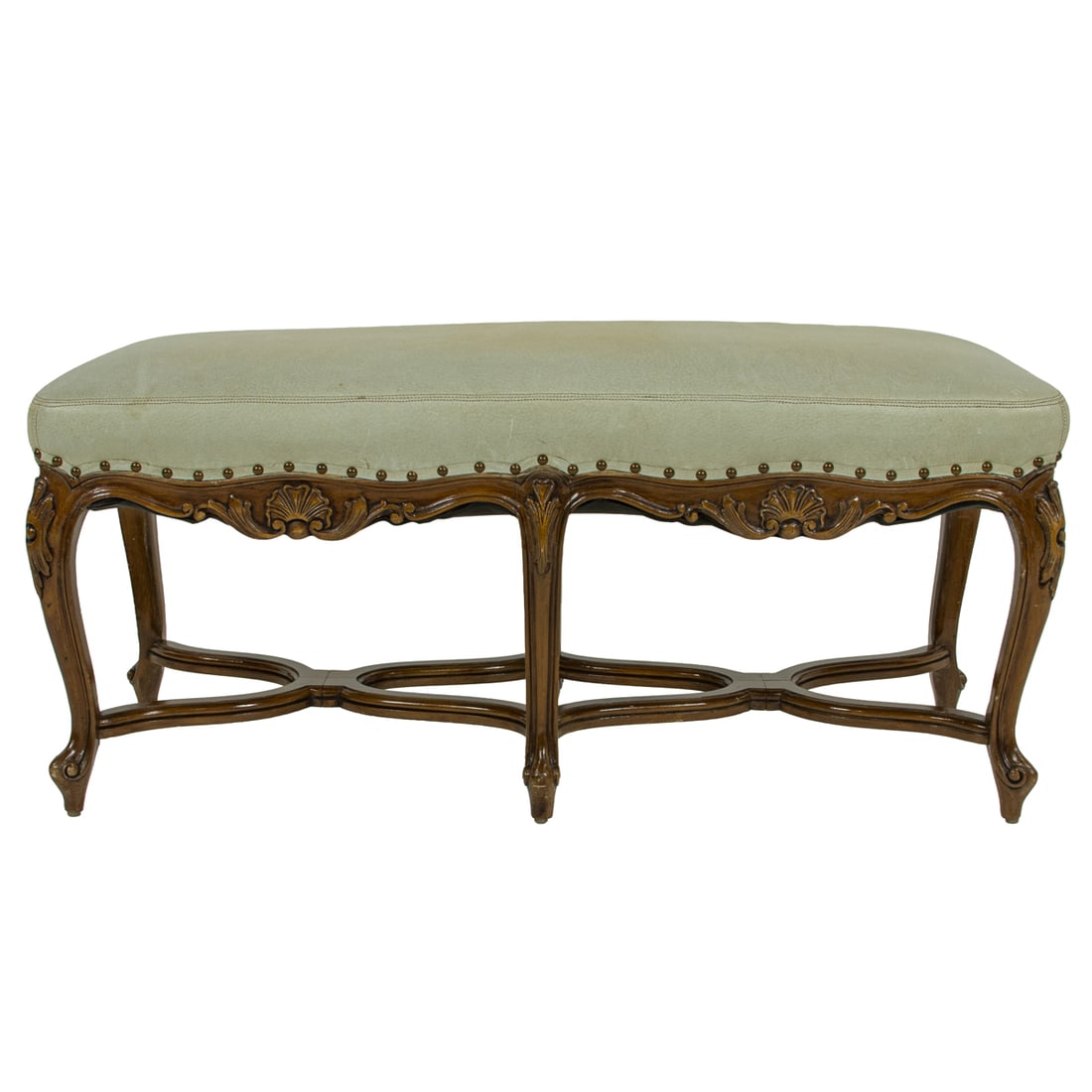 A French leather upholstered window bench: A French leather upholstered window bench, late 19th/early 20th century, with brass nail head trim and rising on carved cabriole legs, 20"h x 42.5"w x 16"d
