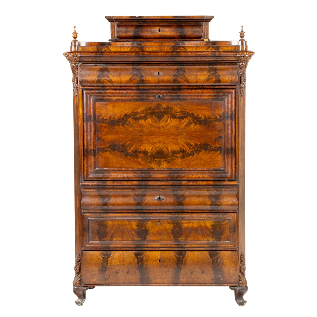 A mahogany Biedermeier secretary: A mahogany Biedermeier secretary, second half 19th century, the highly figured case with a single ogee drawer surmounting the fall front revealing the fitted interior, and rising on carved outswept