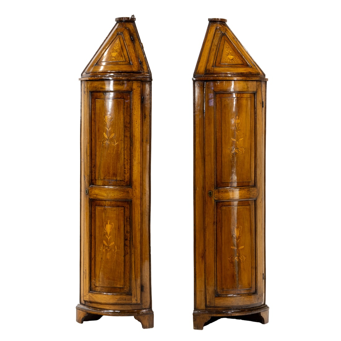 A pair of Italian marquetry decorated corner cabinets late 18th/early 19th century: A pair of Italian marquetry decorated corner cabinets late 18th/early 19th century, the curved case with two doors, each with floral and urn inlaid medallions, and rising on bracket feet, 79"h x 23"w