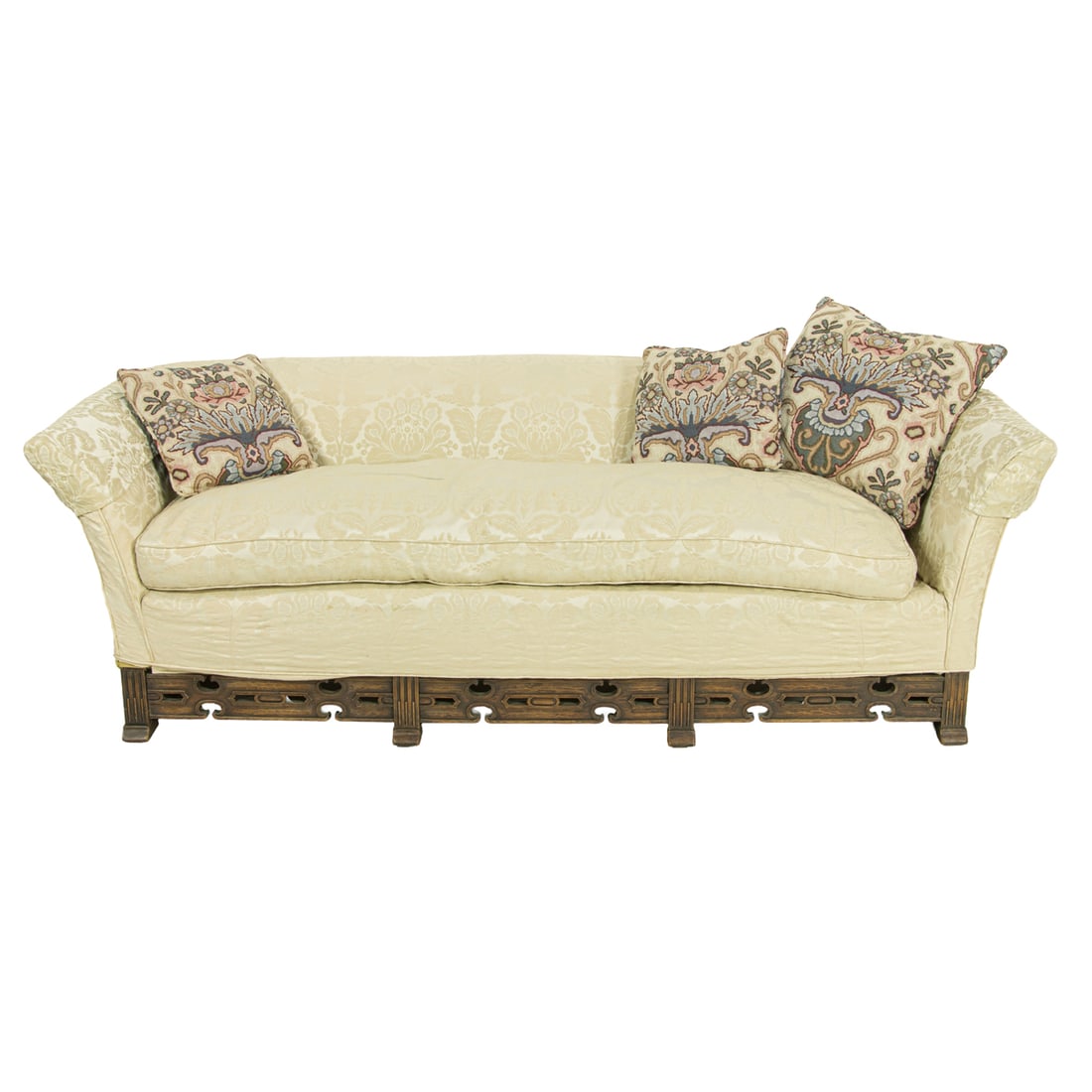 A Spanish Revival sofa circa 1920: A Spanish Revival sofa circa 1920, having a loose down cushion above the carved and pierced lower stretcher, and resting on shoe feet, 28"h x 89"w x 33"d (overall); 22"d (seat)