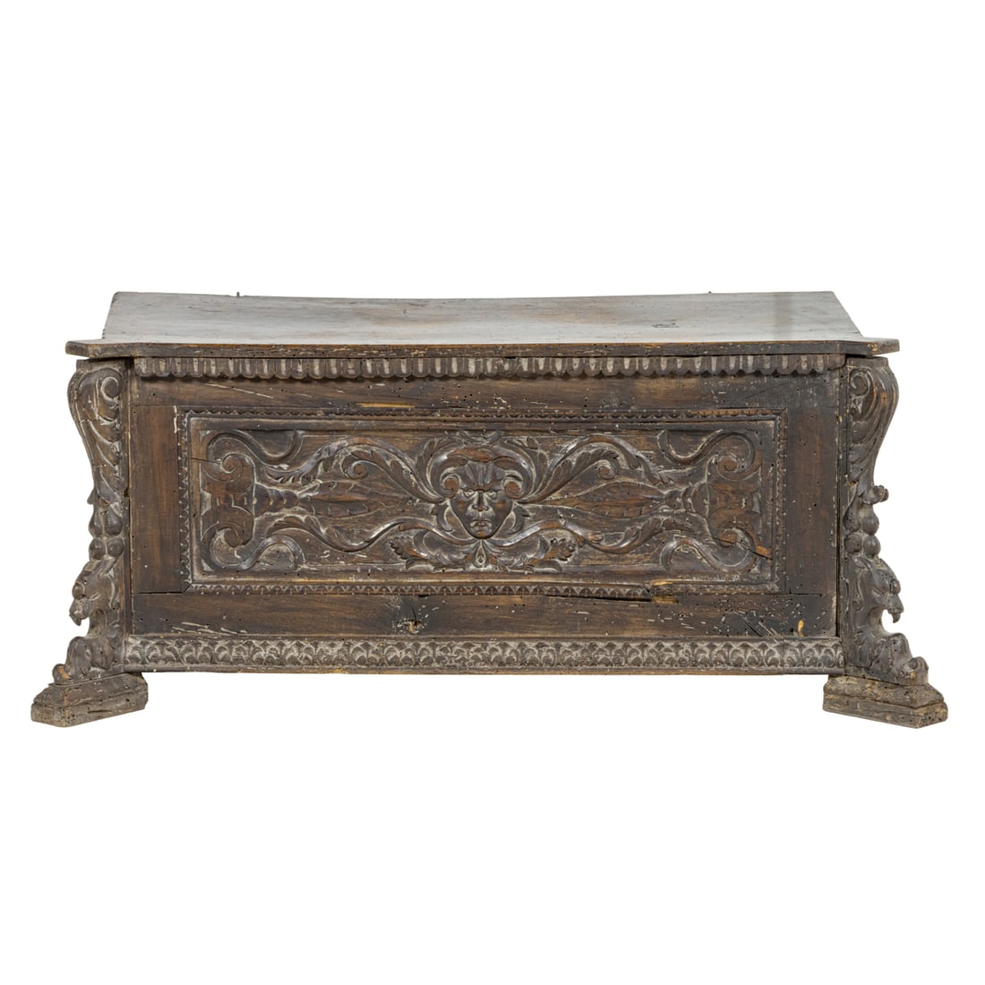 An Italian coffer in the Renaissance taste: An Italian coffer in the Renaissance taste, first half 18th century, the paneled case with a carved frieze centered with the green man medallion, the sides with carved griffin and scroll detail and ri