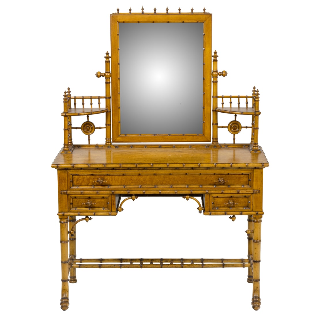 An American Victorian faux bamboo vanity circa 1890: An American Victorian faux bamboo vanity circa 1890, the swivel mirror centering the spindle decorated tiers above the birdseye maple three drawer case with T pulls and rising on outswept faux bamboo 