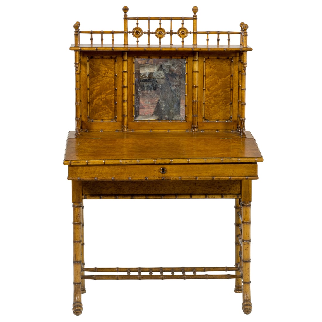 An R.J. Horner American Victorian faux bamboo desk in the Aesthetic taste circa 1880: An R.J. Horner American Victorian faux bamboo desk in the Aesthetic taste circa 1880, the mirrored top with spindle gallery above the lower case having a slightly canted overhanging top and hinged lid