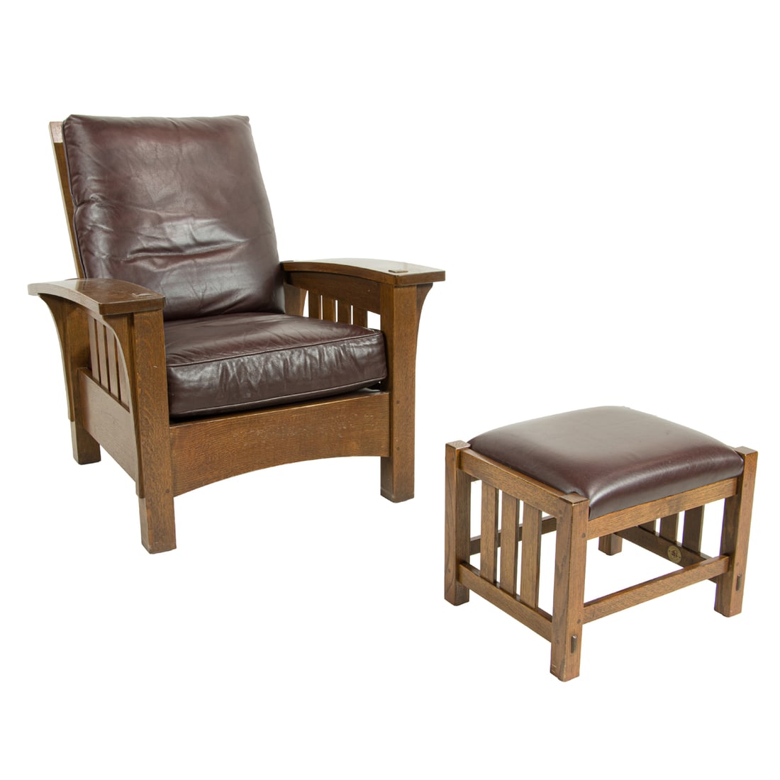 A Stickley Audi Arts and Crafts style bow arm morris chair and ottoman: A Stickley Audi Arts and Crafts style bow arm morris chair and ottoman, executed in white oak and leather, marked with both metal and branded mark, dated October 2011. This example was modeled after L