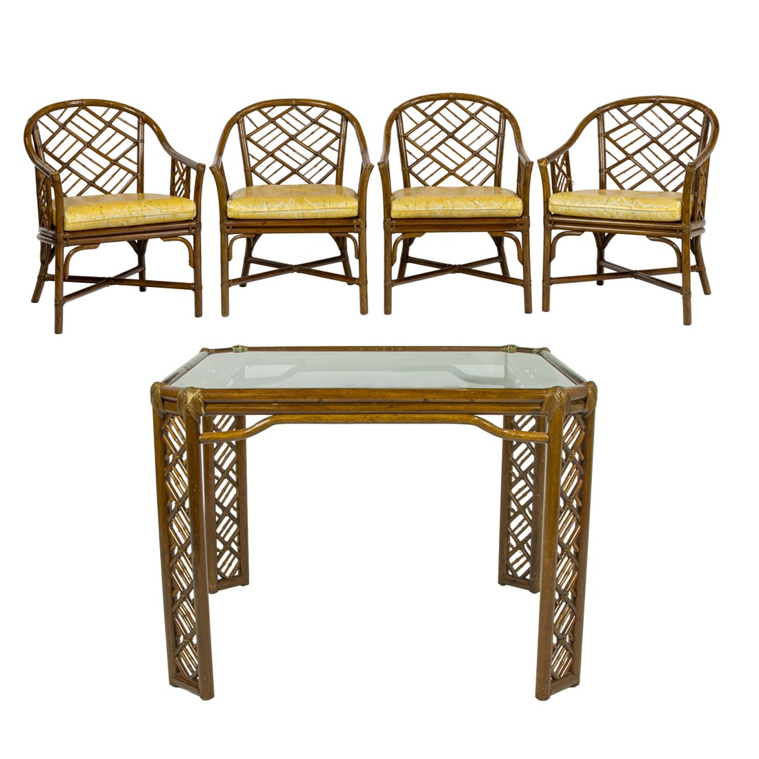 A McGuire style bamboo breakfast suite: A McGuire style bamboo breakfast suite, the four armchairs with a bow back and loose original cushion on a cane foundation, and a glass top table with bamboo frame, table 29"h x 39.5"sq: chairs 31"h x