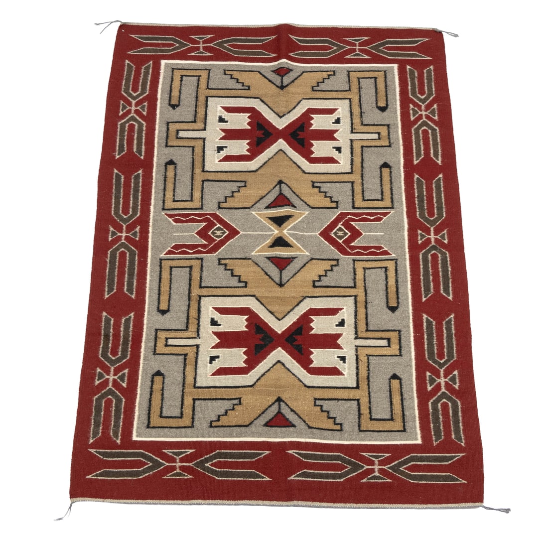 A Navajo blanket: A Navajo blanket, woven in tones of red, grey and tan, 58.5"l x 40.5"w