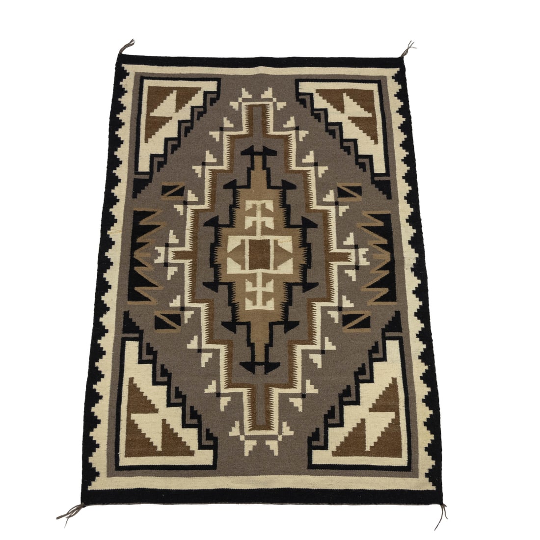 A Navajo blanket: A Navajo blanket, woven in tones of black, brown and ivory, 57"l x 37"w