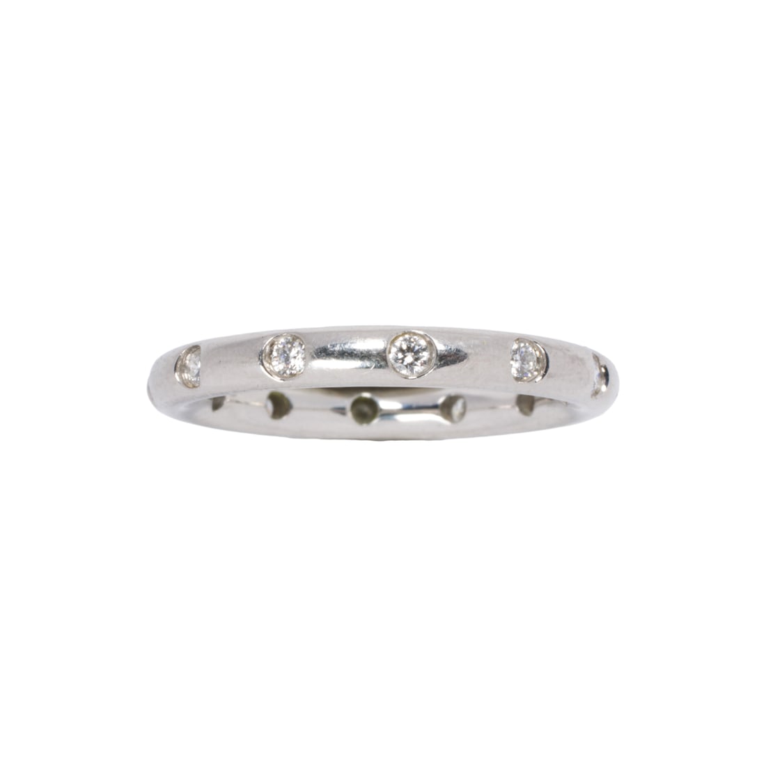 A Tiffany & Co. diamond and platinum band: A Tiffany & Co. diamond and platinum band Designed as a band set with 12 round brilliant-cut diamonds; size 6 1/2; 5.75 grams