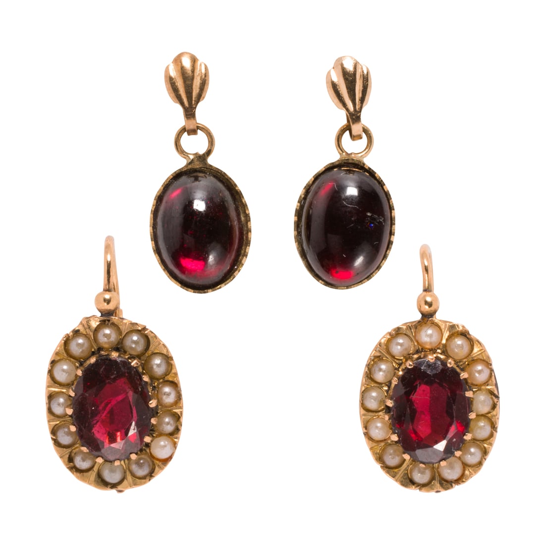 Two pairs of antique garnet and gold earrings: Two pairs of antique garnet and gold earrings Comprising one pair set with oval-cut garnets measuring 8.19 x 5.92 x 2.92 mm, framed by a halo of seed pearls, set in 18k gold, together with one pair fe
