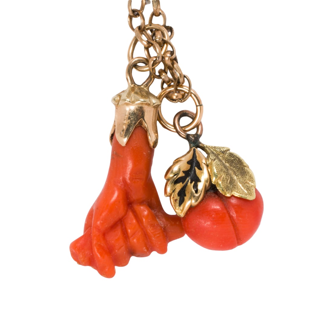 An antique coral, 10k, and 9k gold pendant necklace: An antique coral, 10k, and 9k gold pendant necklace The pendants designed as a Figa and a peach mounted in 10k gold, on 9k gold cable-link chain; pendant lengths: 1 1/4 and 7/8 in, respectively;
