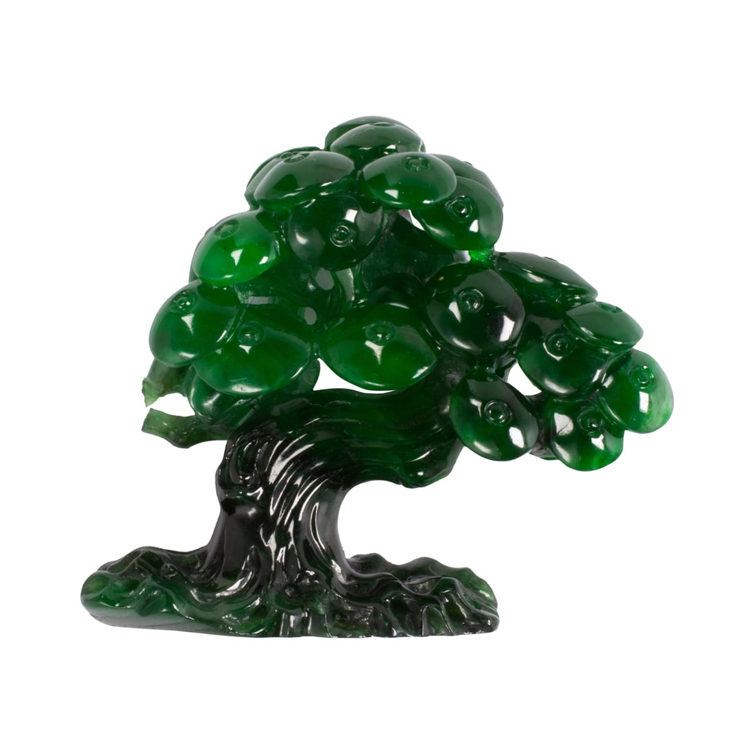 A carved jade tree: A carved jade tree Measuring approximately 27.50 x 31.00 x 13.52 mm; length: 1 in; 7.70 grams Accompanied by GIA report no. 1232780273, dated November 18, 2025, stating Jadeite and Richterite,