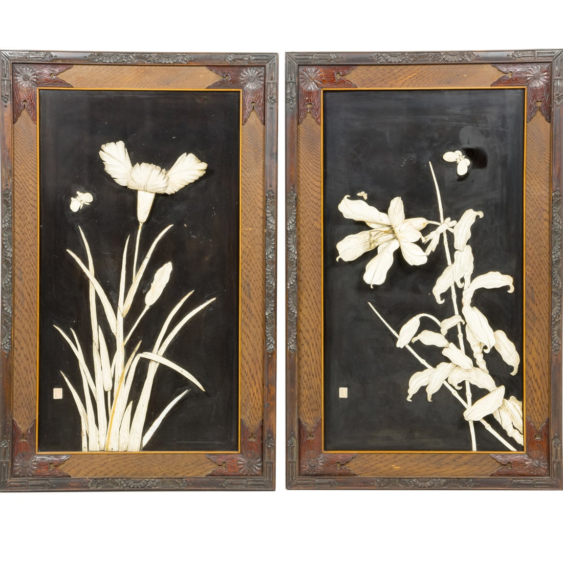 A pair of Japanese bone inlaid lacquered panels: A pair of Japanese bone inlaid lacquered panels. Of rectangular form, the black ground inlaid in relief with a blossoming lily and iris, Meiji period, 35.625"h x 22.5"w.