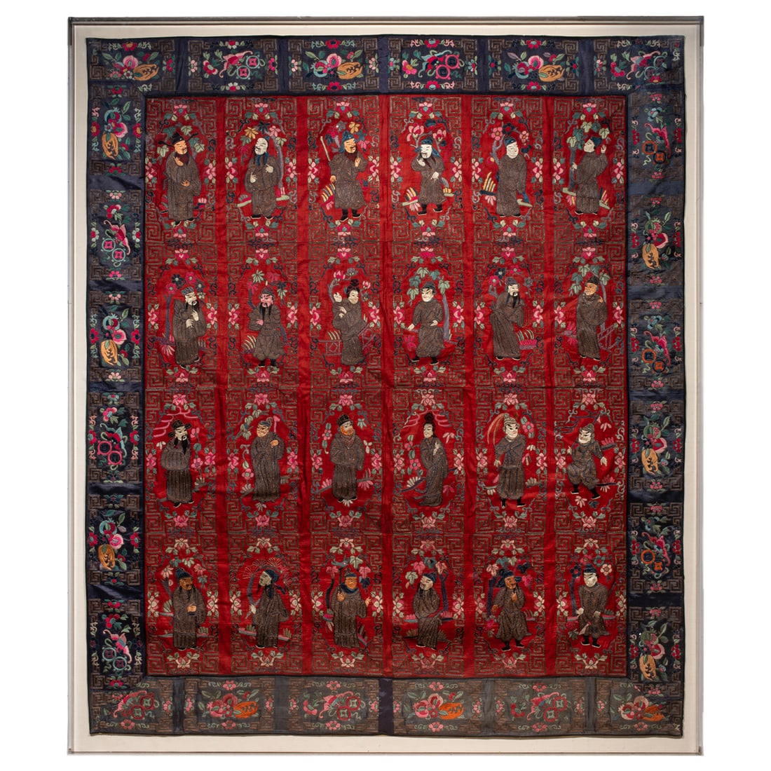 A large Chinese embroidered silk red-ground Daoist tapestry: A large Chinese embroidered silk red-ground Daoist tapestry. Featuring 24 Daoist figures within decorative borders highlighting various auspicious symbols, 19th century, framed and glazed, 73"h x 63"w