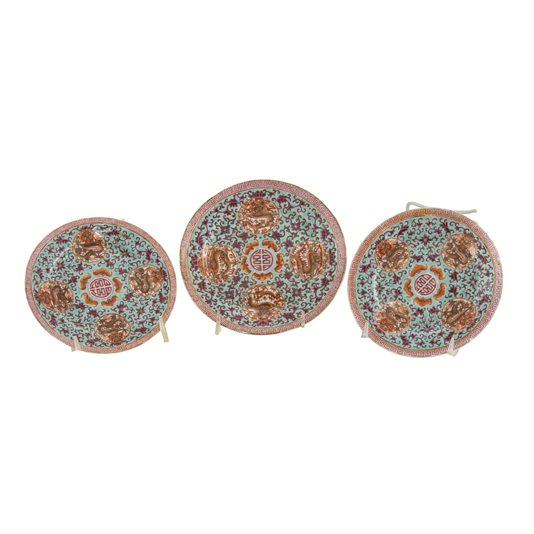 (lot of 3) Chinese famille rose 'dragon medallion' dishes: (lot of 3) Chinese famille rose 'dragon medallion' dishes. Featuring four roundels enclosing writhing dragons, surrounding a central shou medallion encircled by iron-red bats, bearing Qianlong six-cha