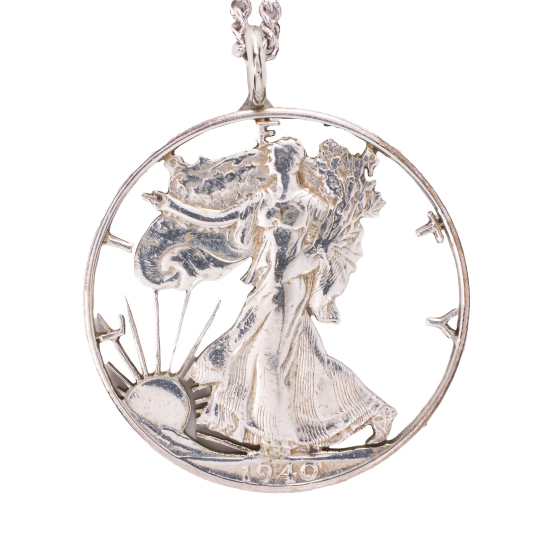 A 1940 Walking Liberty half dollar coin necklace: A 1940 Walking Liberty half dollar coin necklace Featuring a cut out Walking Liberty half dollar coin on curb link chain; pendant length: 1 1/2 in; chain length: 24 in; 14.85 grams