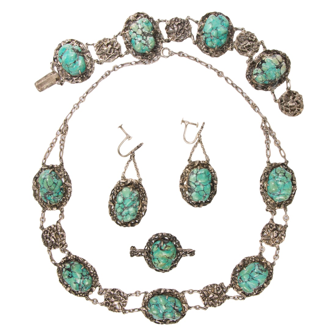 A turquoise and metal suite: A turquoise and metal suite Comprising a necklace, bracelet, pair of ear-clips, and pin, designed with free-form polished turquoise pieces, within botanical-themed open-form metal settings; necklace l