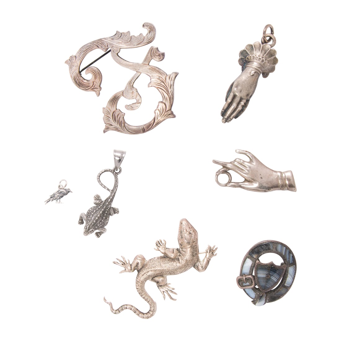 A group of sterling silver and silver-tone jewelry: A group of sterling silver and silver-tone jewelry Comprising seven pieces of jewelry of varying styles and materials including sterling silver; gross weight: 57.70 grams