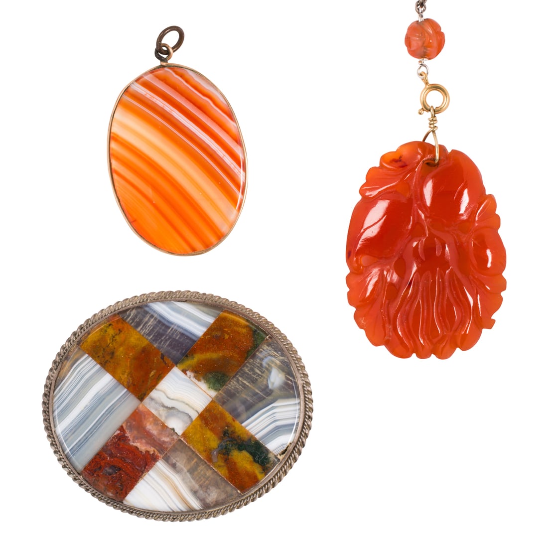 A group of carnelian jewelry: A group of carnelian jewelry comprising a carnelian and mixed hardstone brooch in silver, a gold-filled pendant, and a base metal necklace; necklace length: 26 in; pendant lengths: 1/2 in; brooch leng