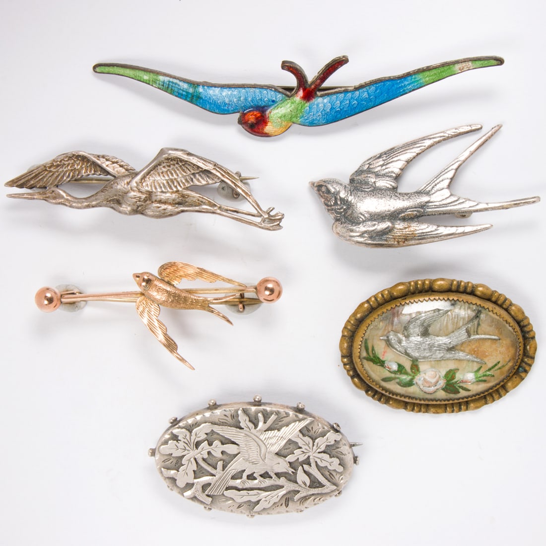 Seven antique bird pins: Seven antique bird pins Comprising seven pins featuring bird motifs of varying styles and materials including 9k gold and sterling silver; gross weight: 33.25 grams