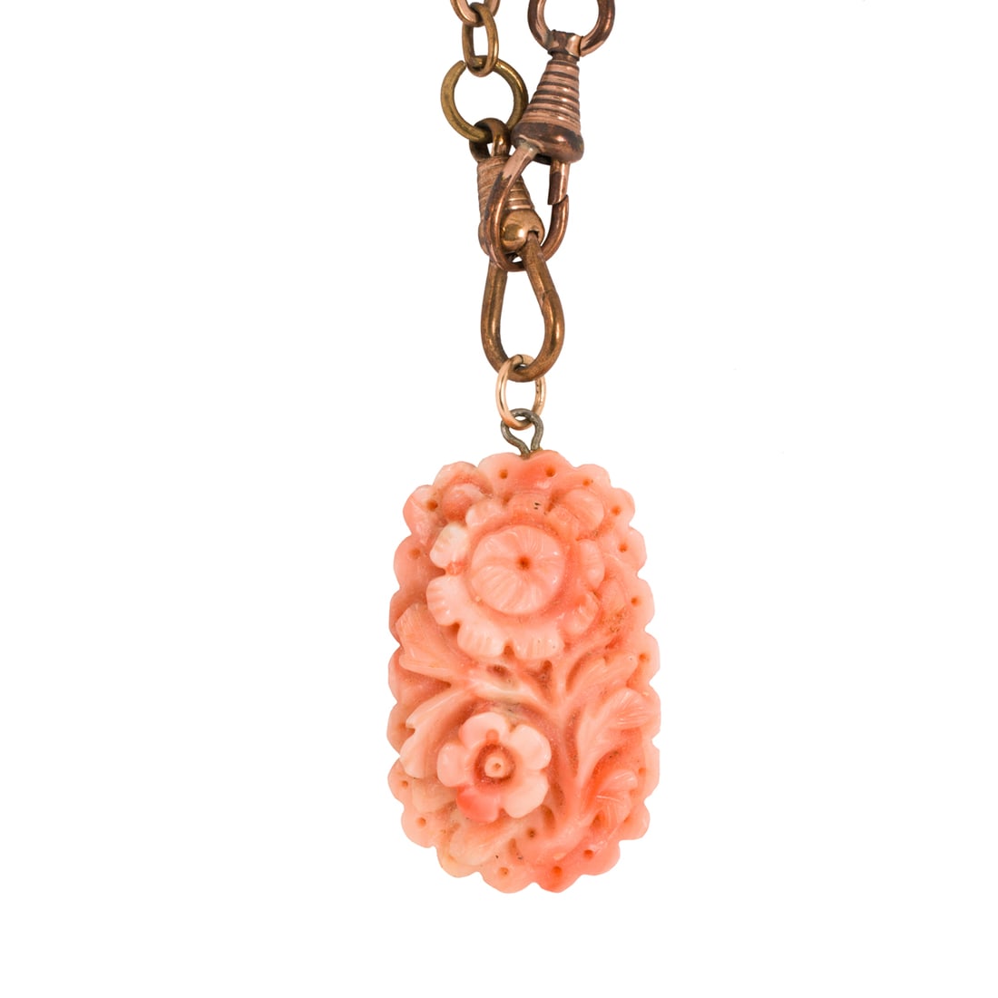 An antique coral and gold-filled pendant necklace: An antique coral and gold-filled pendant necklace The coral pendant of floral design, on fancy link gold-filled pocket watch chain; pendant length: 1 3/4 in; chain length: 20 in; 19.60 grams