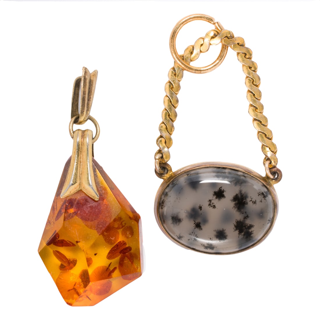 Two gold-filled pendants: Two gold-filled pendants Comprising one agate and one composite amber pendant within gold-filled settings; gross weight: 6.75 grams