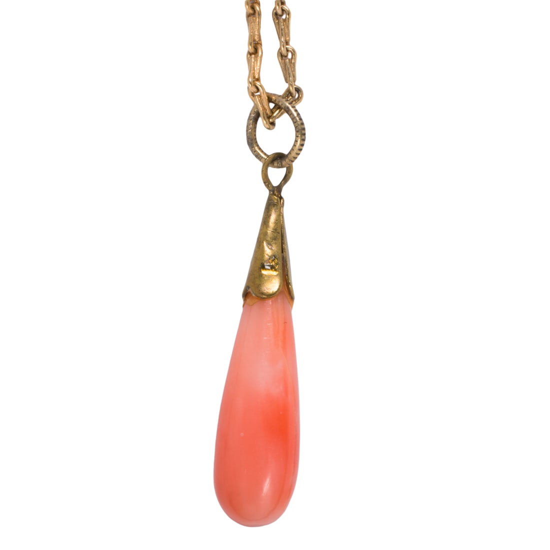 A coral and gold-filled pendant necklace: A coral and gold-filled pendant necklace The pendant designed with a coral drop measuring 25.31 x 6.33 mm, on fancy-link chain; pendant length: 1 1/4 in; chain length: 18 in; 3.80 grams