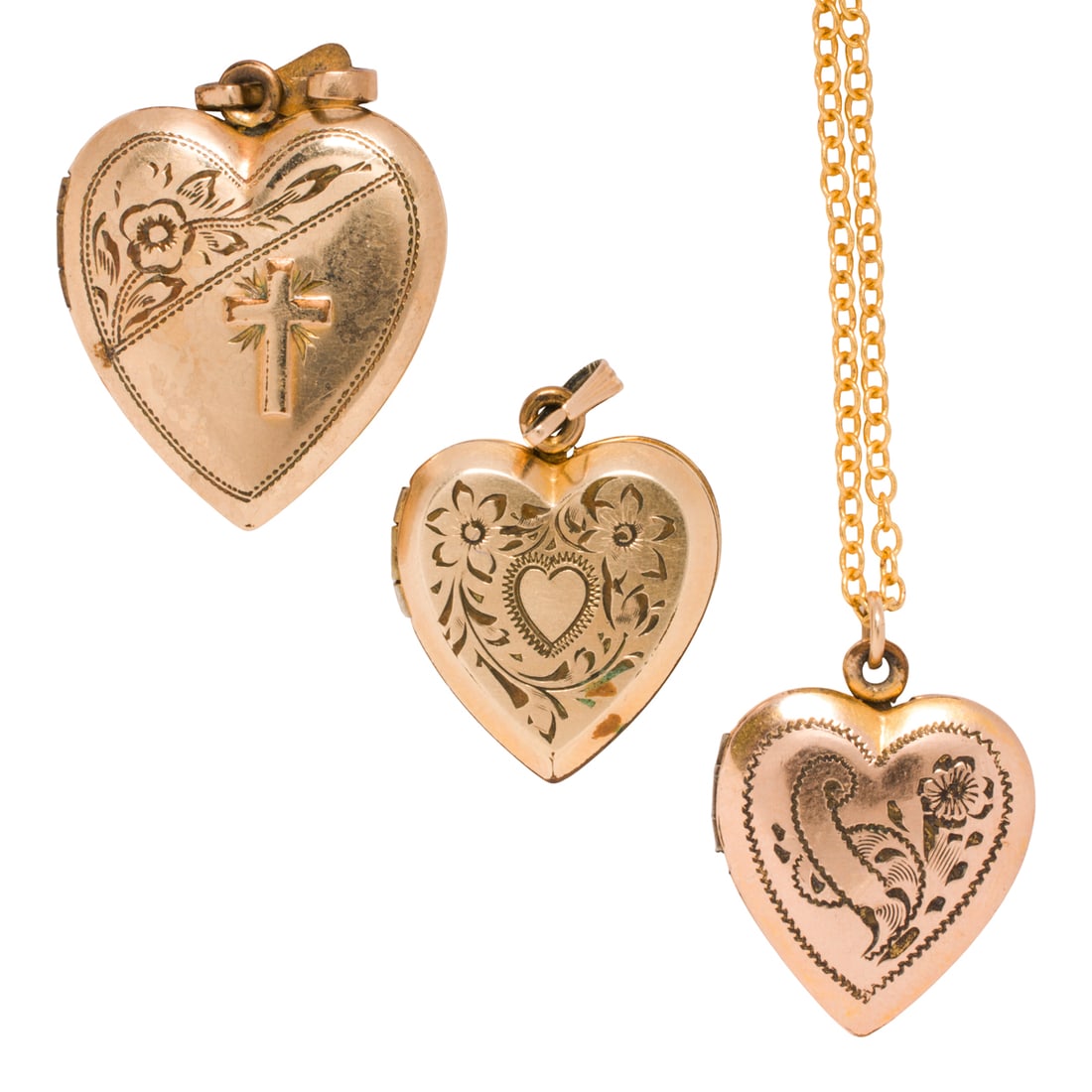Three antique gold filled lockets: Three antique gold filled lockets Comprising three heart-shaped gold-filled lockets each accented by etched scrolling, together with one modern gold-filled chain; gross weight: 13.50 grams