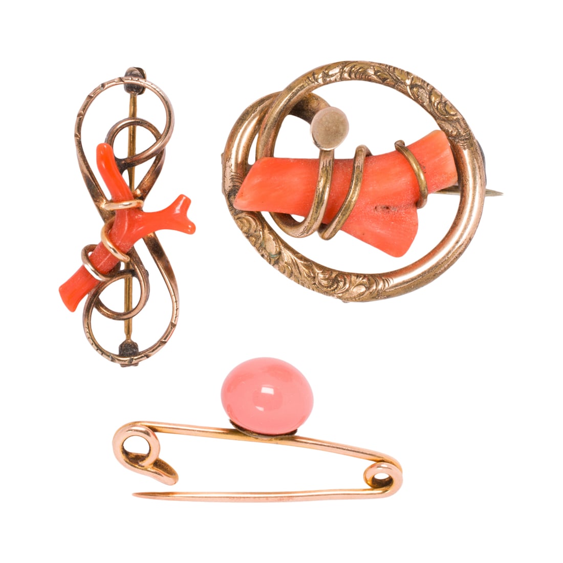 Three antique coral pins: Three antique coral pins Comprising one 14k gold and two gold-filled pins set with polished coral pieces; gross weight: 12.95 grams