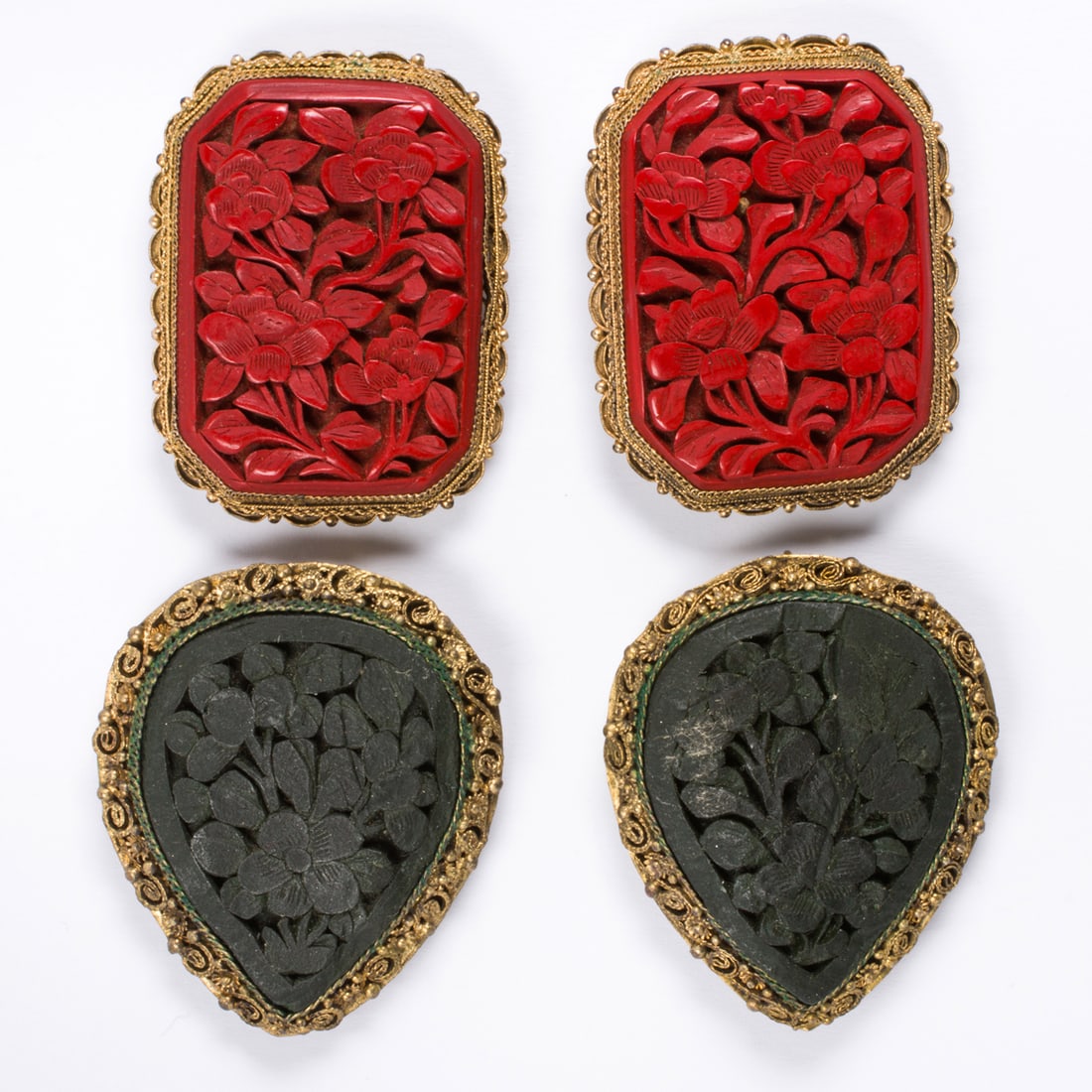 Four gilt silver pins: Four gilt silver pins Comprising four intricately carved gilt silver pins of varying materials including cinnabar; gross weight: 49.35 grams
