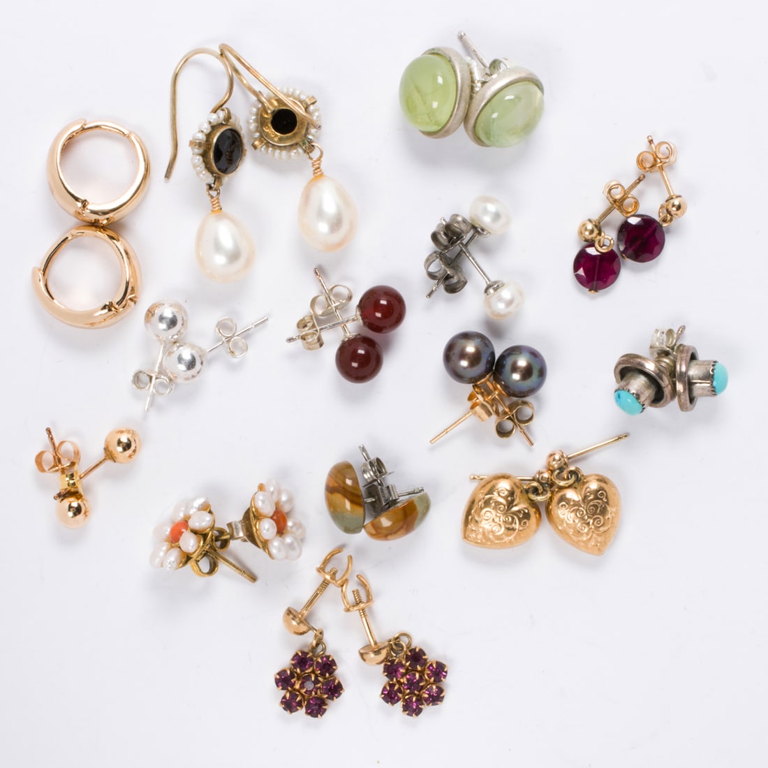 Seventeen pairs of miscellaneous earrings: Seventeen pairs of miscellaneous earrings The earrings designed with a variety of materials including silver and 14k gold; gross weight: 28.75 grams