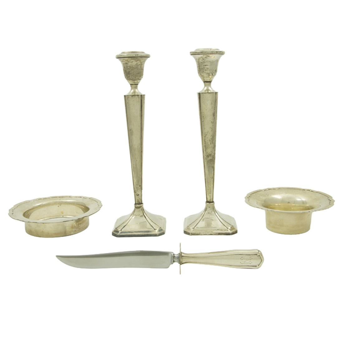 A group of sterling table articles including Shreve and Co: Five sterling and sterling weighted table articles, comprising (1) Shreve & Co., San Francisco wine coaster, 5.625"dia; (1) Shreve & Co., San Francisco bowl, 5.125"dia; (1) pair of weighted candlestic