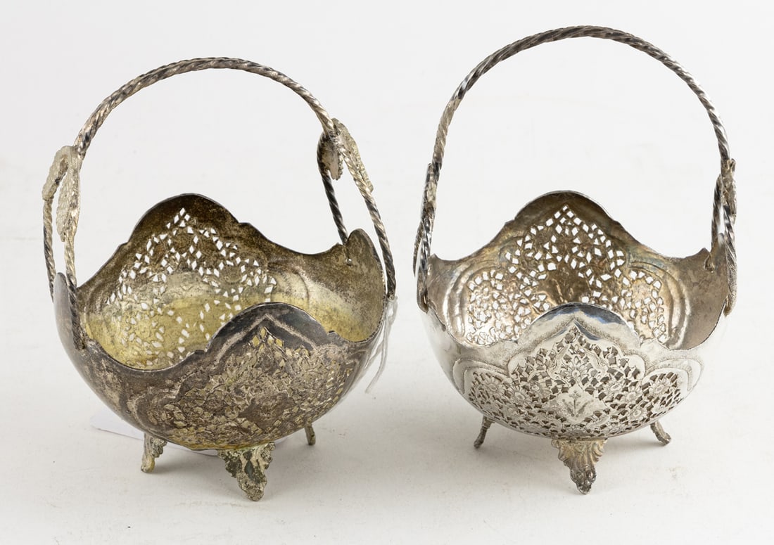 A pair of Persian pierced silvered footed baskets: A pair of Persian pierced silvered footed baskets, fitted with fixed rope form handles, unmarked, 6.5"h x 4.5"w