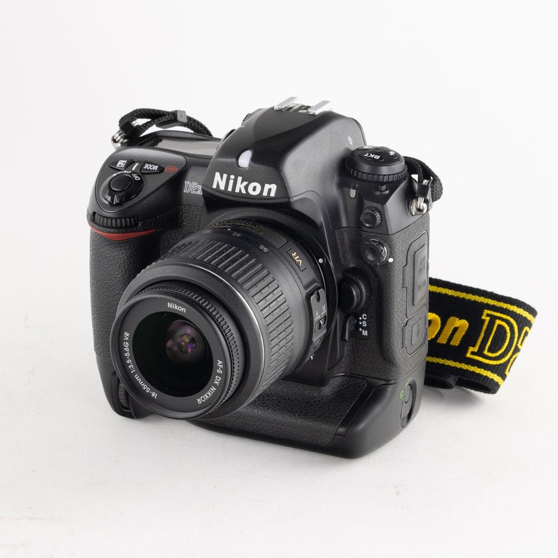 A Nikon D2XS dslr camera: A Nikon D2XS dslr camera, soft case, charger and battery, two lenses and accessories [8 total]