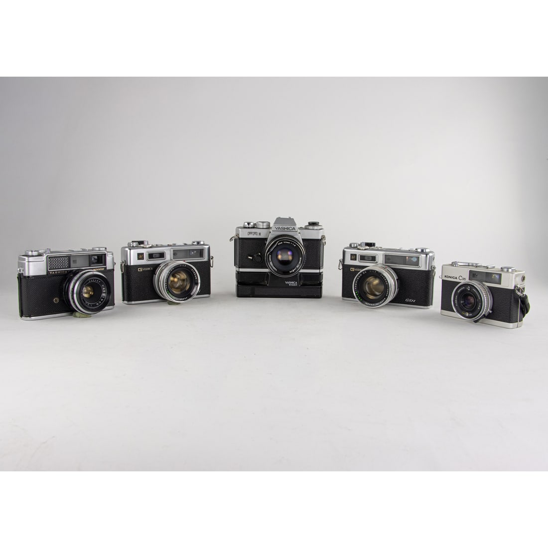 A group of mainly Yashica 35mm cameras: A group of mainly Yashica 35mm cameras, four Yashica's, one Konica C35 [5 total]