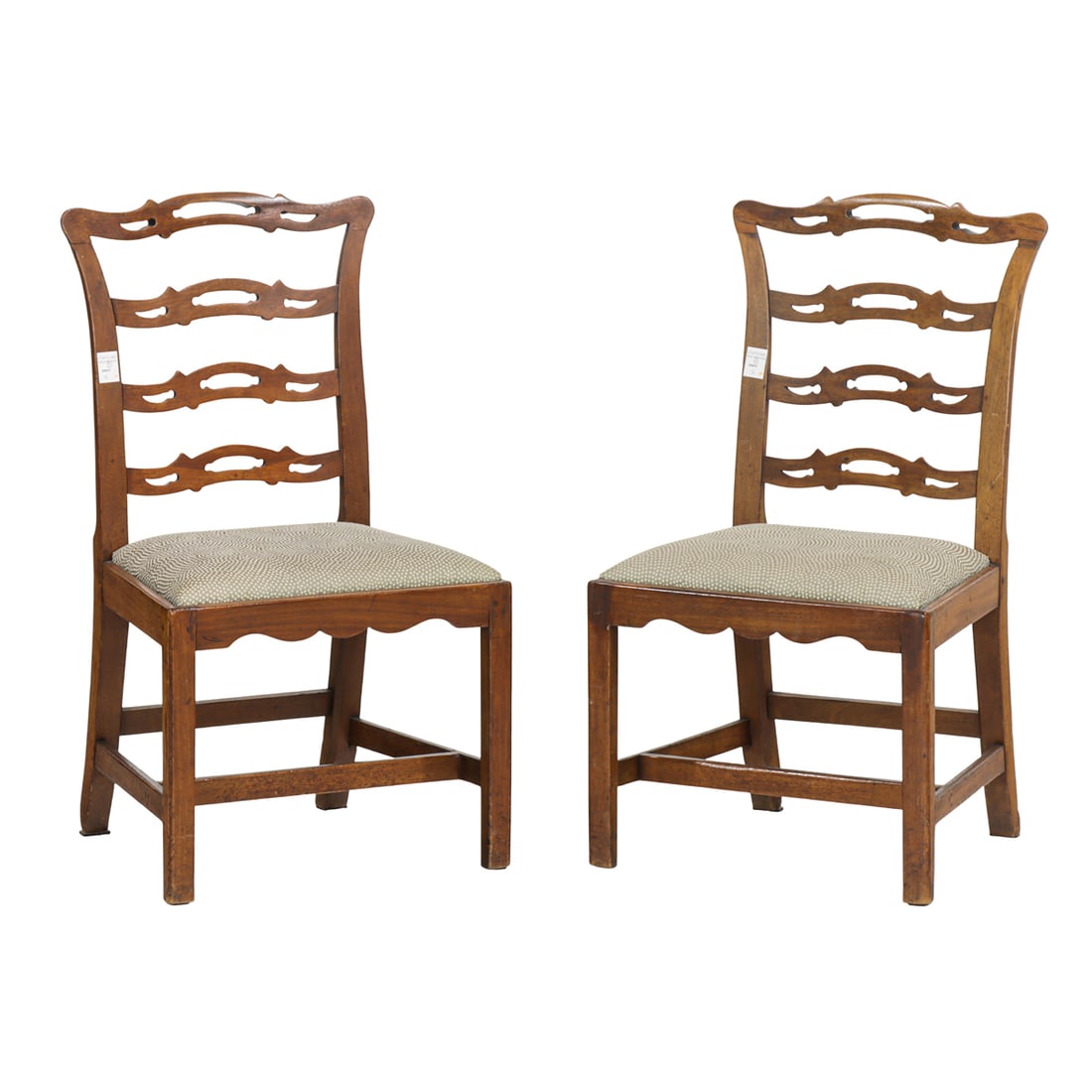 A pair of George III mahogany ladder back side chairs: A pair of George III mahogany ladder back side chairs, late 18th century, each back with with pierced horizontal slats, overall trapezoidal slip-in seat, raised on straight molded legs joined by an H-