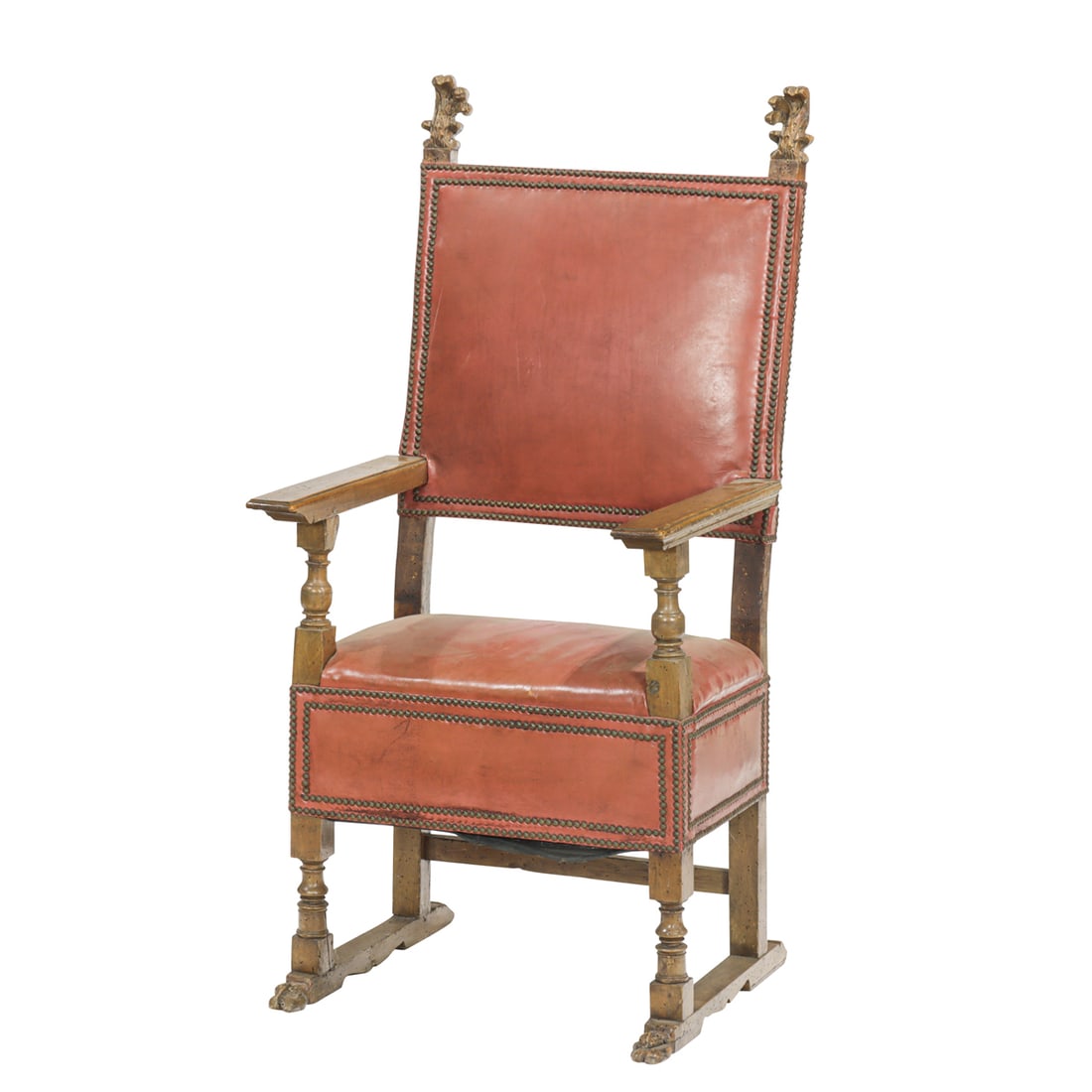 A Spanish Baroque leather upholstered hall chair: A Spanish Baroque leather upholstered hall chair, 18th century, highback with leaf finials, straight arms, over rectangular seat with deep apron, raised on turned legs ending in pied-de-biche, 55"h x