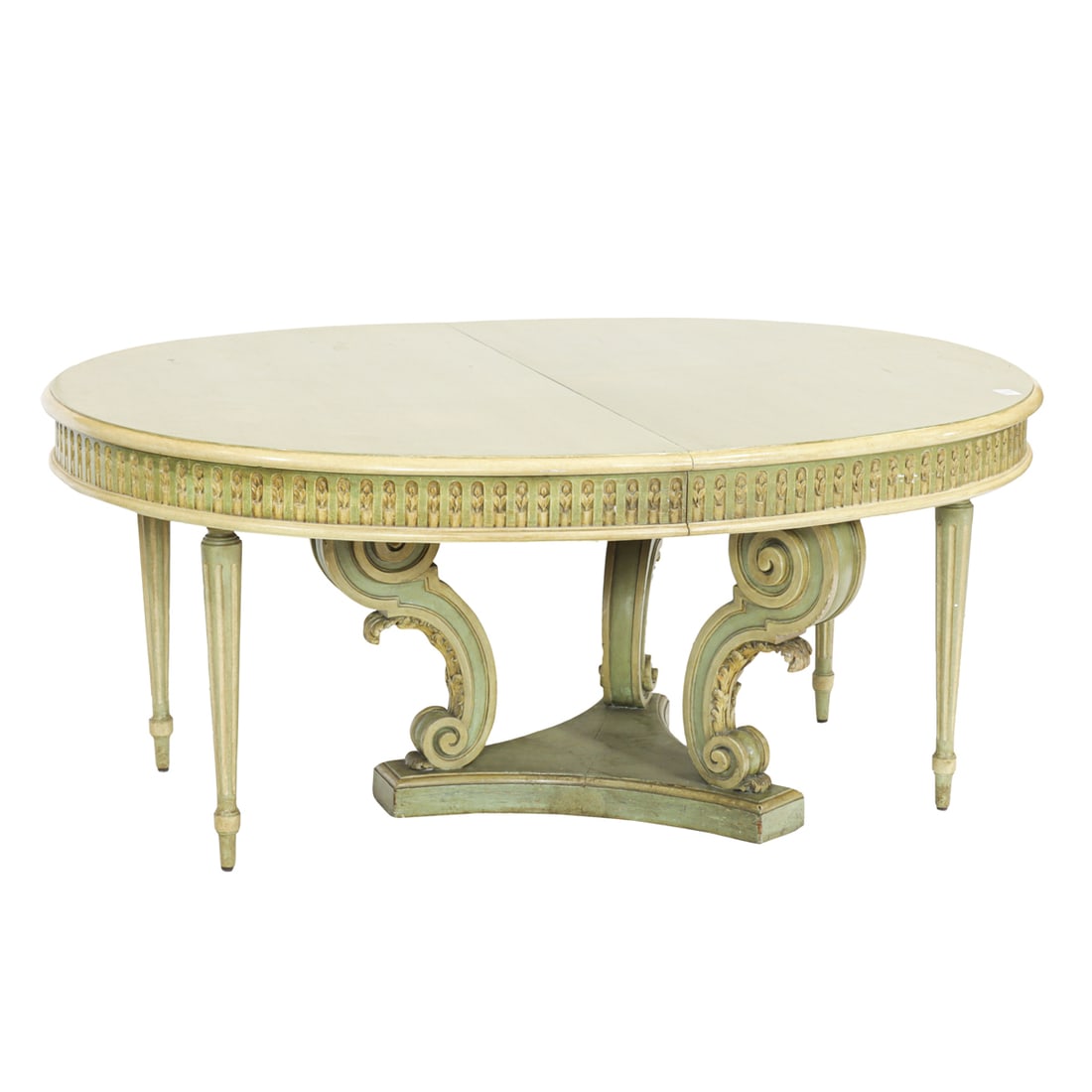 A Neoclassical style painted oval extension dining table: A Neoclassical style painted oval extension dining table, second half 20th century, the top with a molded edge and fluted apron, raised on scrolled pedestals and fluted legs, includes four 29.5"