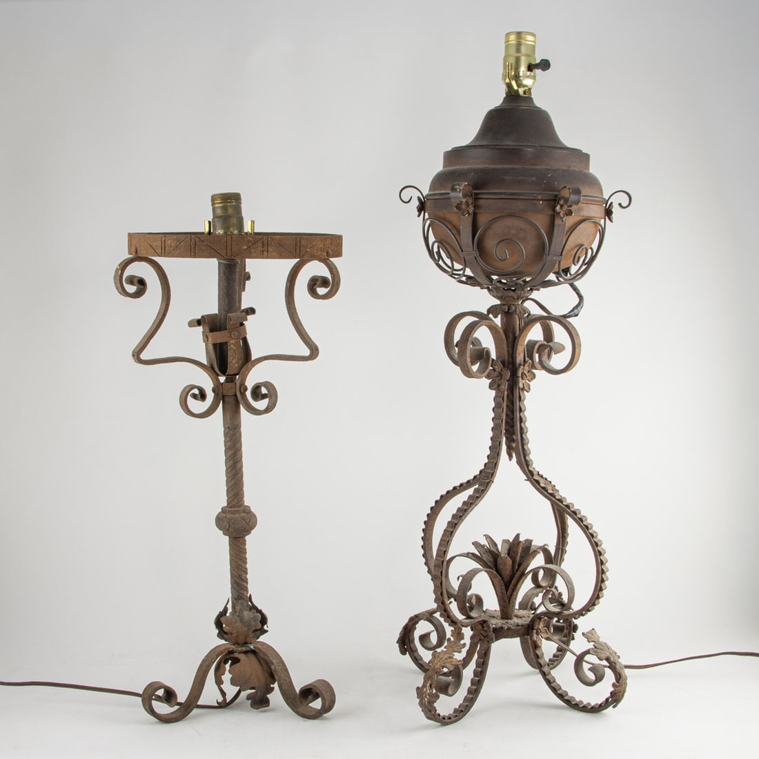 Two Spanish Baroque style wrought iron table lamps: Two Spanish Baroque style wrought iron table lamps, 21"h and 26"h (excluding electrical fittings)