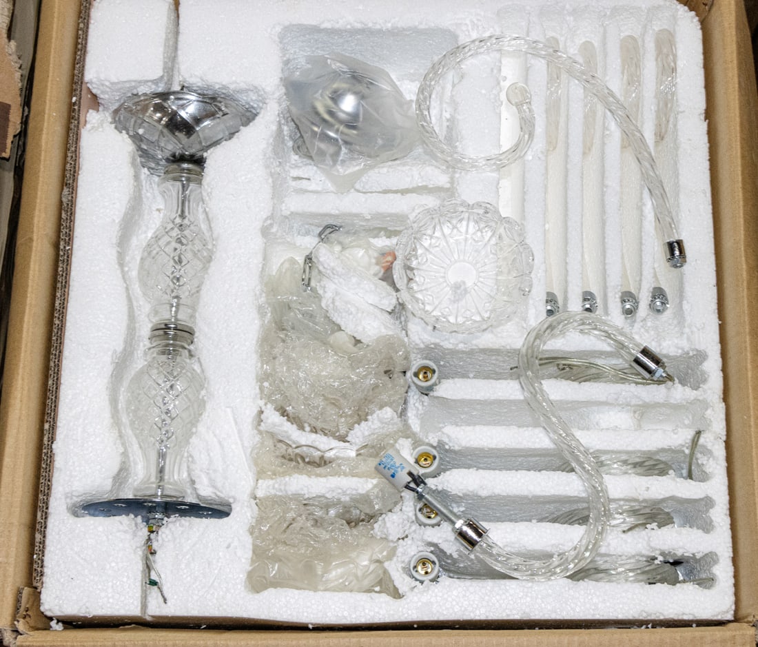 A group of six unused Waterford style glass chandeliers: A group of six unused Waterford style glass chandeliers, in the Venetian taste, each with five lights, separated by five candy cane accents, all wrapped in foam and plastic in box