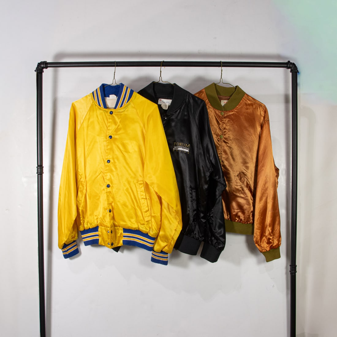Three vintage satin jackets: Three vintage satin jackets, (1) black "Ring Siders Club" size large, (1) burnt orange "Beverly Hills Polo Lounge" size not labeled, (1) yellow "Trike On" size medium