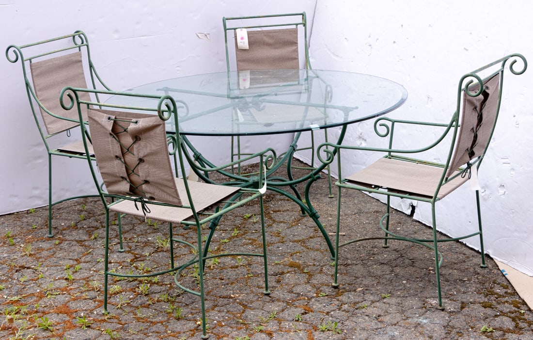 A green painted cast iron patio dining set: A green painted cast iron patio dining set, comprising four chairs with canvas upholstery, 39"h x 20"w x 25"d and glass topped dining table 29"h x 54"w
