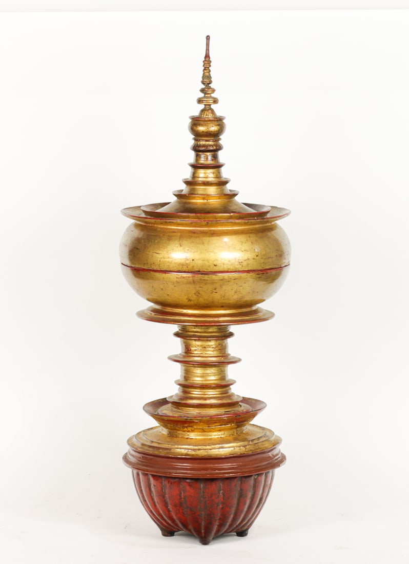 A Burmese gilt lacquered offering container: A Burmese gilt lacquered offering container. Early 20th century, 30.5" high.