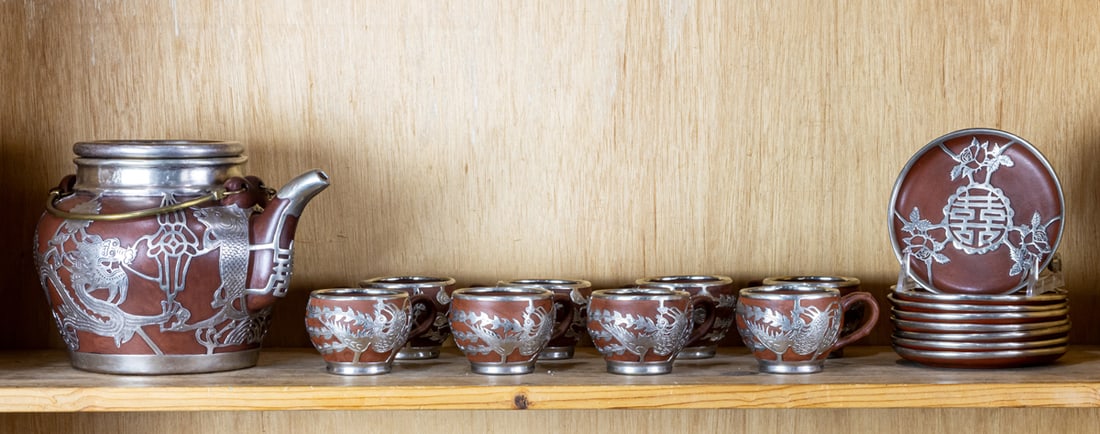 (lot of 17) Chinese pewter mounted Yixing tea set: (lot of 17) Chinese pewter mounted Yixing tea set. Republic period, 4.25" to 9.5" wide.