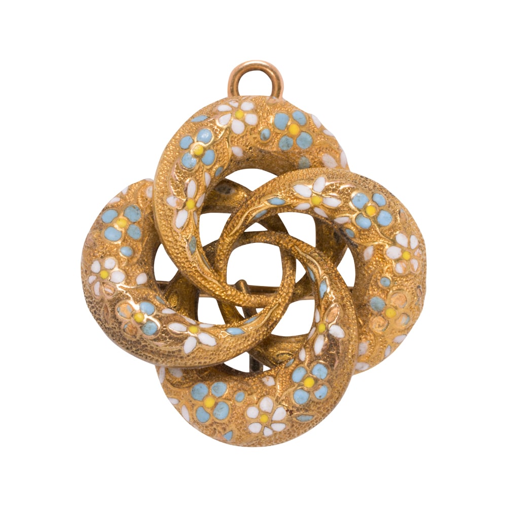 A Victorian enamel and 14k gold brooch-pendant: A Victorian enamel and 14k gold brooch-pendant of stylized floral design, accented by floriform enameling; length: 1 1/8 in; 7.00 grams