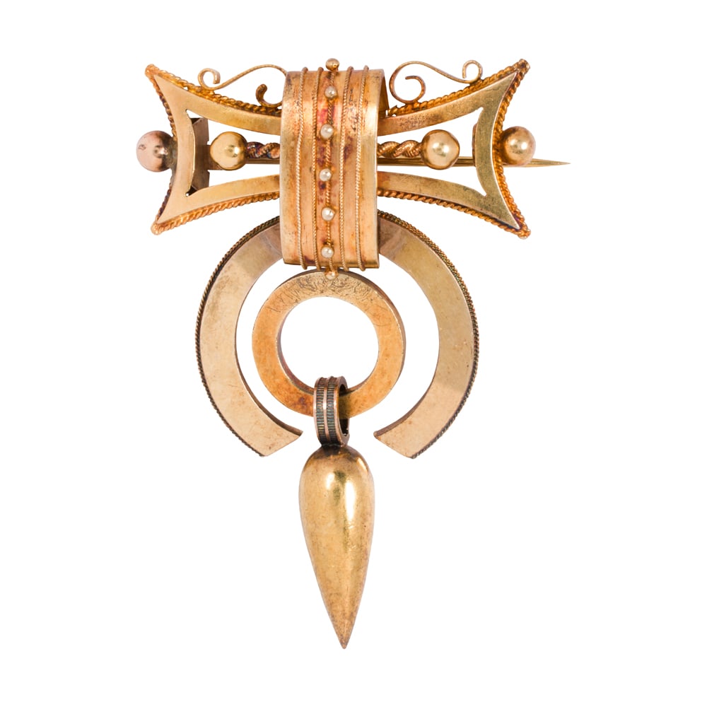 A Victorian gold brooch: A Victorian gold brooch Designed as a an assemblage of gold parts from 9k gold to 18k gold; length: 2 1/4 in; 8.90 grams