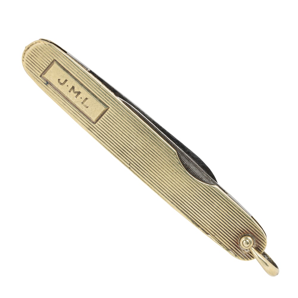 A 14k gold and stainless steel utility knife: A 14k gold and stainless steel utility knife The outer case designed with striped etching, containing a knife and a nail file; monogrammed JML; length: 2 3/4 in; 15.40 grams