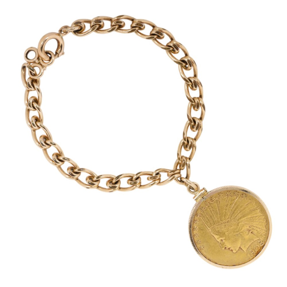 A gold coin bracelet: A gold coin bracelet Featuring a 1908 US Indian Head $10 dollar coin, within a 14k gold frame, suspended from gold-filled chain; length: 7 in; gross weight: 29.50 grams