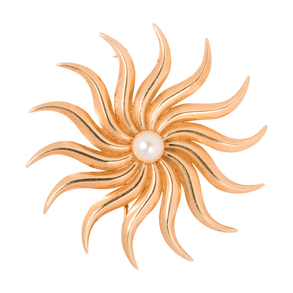 A cultured pearl and 14k gold brooch: A cultured pearl and 14k gold brooch Designed as starburst, centering a cultured pearl measuring 7.01 mm; width: 2 in; 9.15 grams