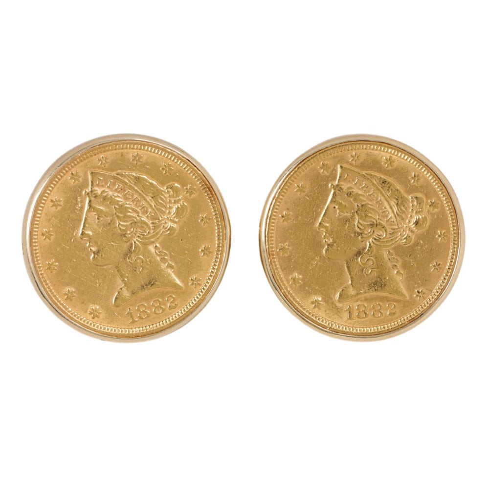 A pair of gold coin and 14k gold cufflinks: A pair of gold coin and 14k gold cufflinks The cufflinks featuring two 1882 US Liberty Head gold coins set within 14k gold; 26.00 grams