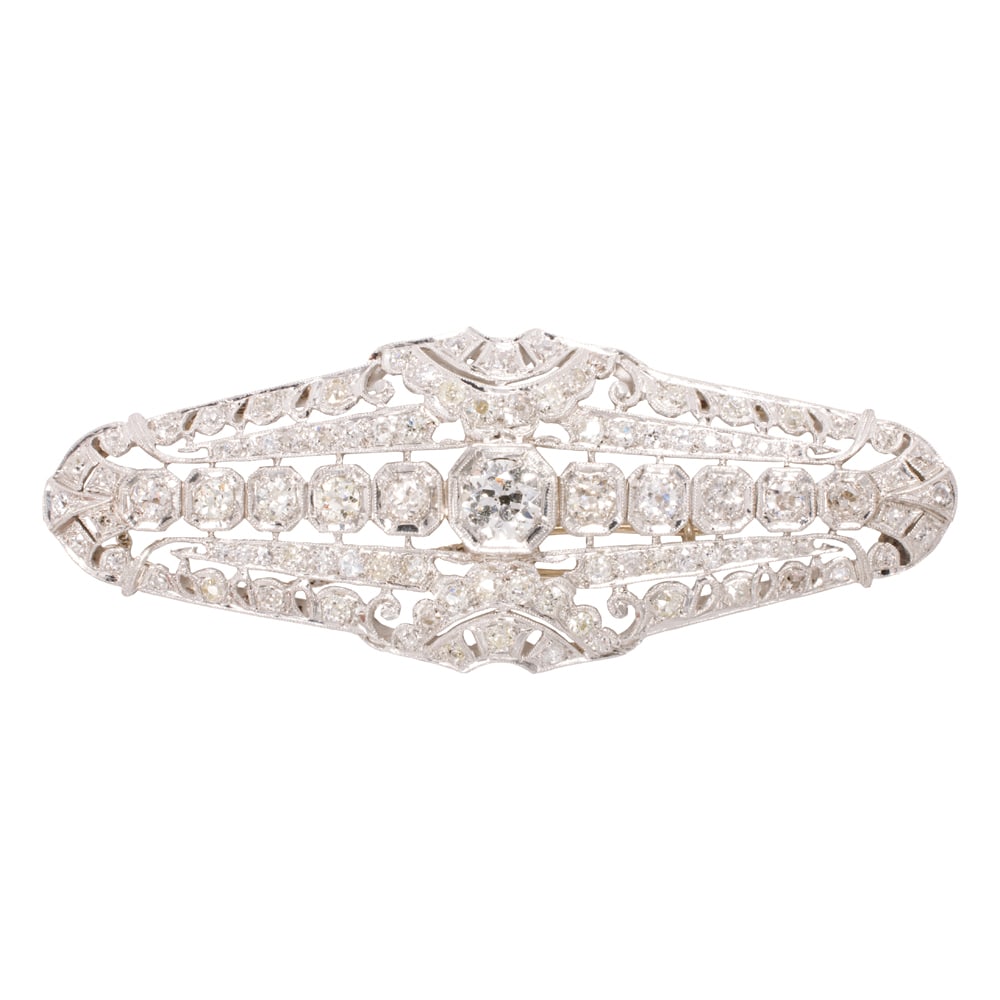 A diamond and platinum brooch: A diamond and platinum brooch circa 1940-50's, set with 95 transitional and old round-cut diamonds, weighing in total estimated 4.25 carats; length: 2 3/4 in; 18.26 grams